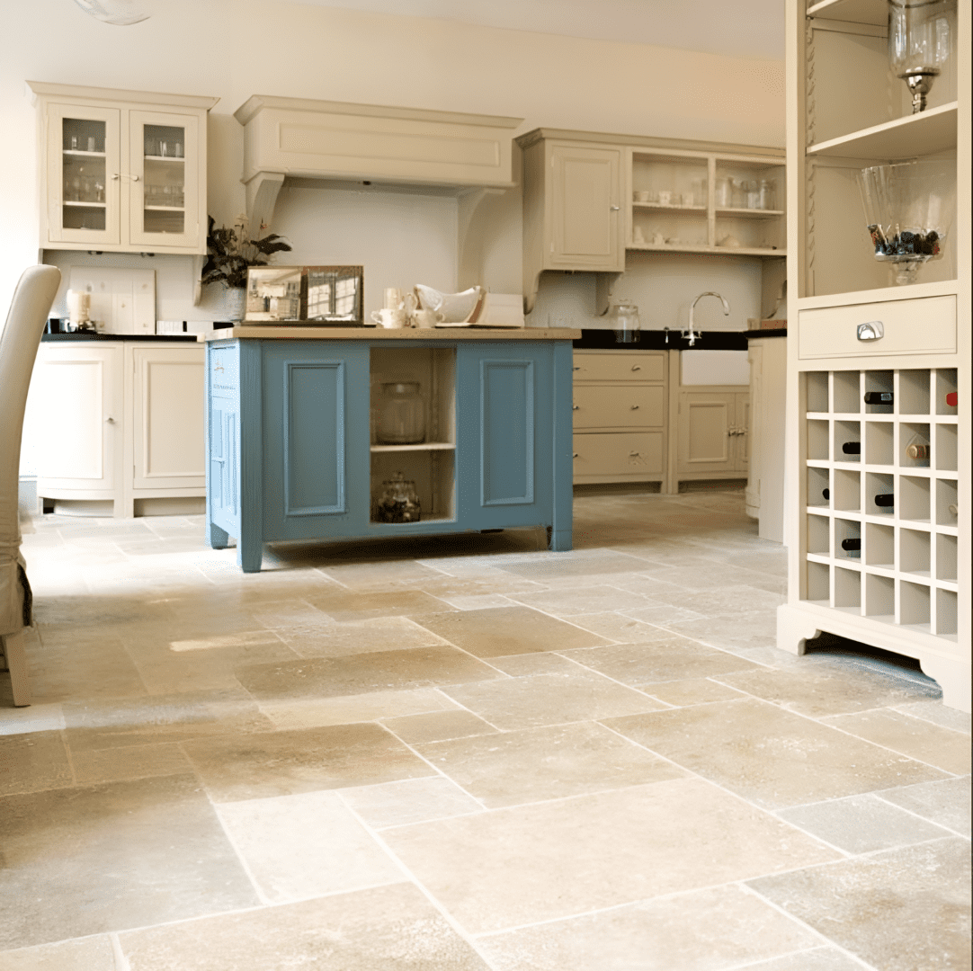 Kitchen with a tiled floor, beige cabinets, and a blue island.