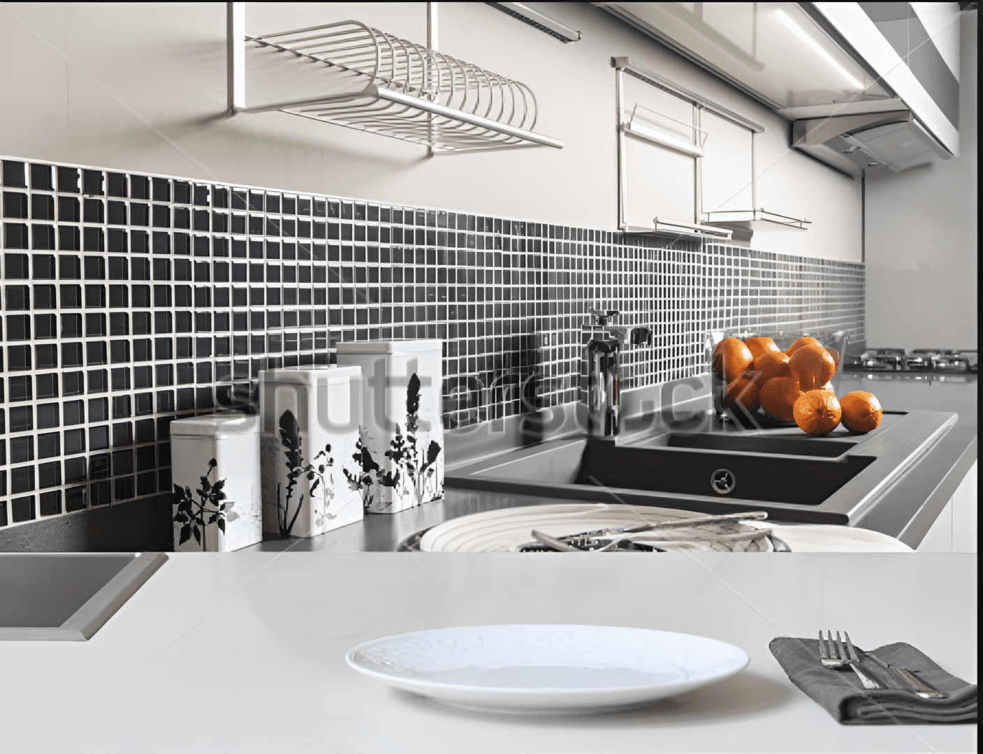 Modern kitchen with a black and white mosaic tile backsplash.
