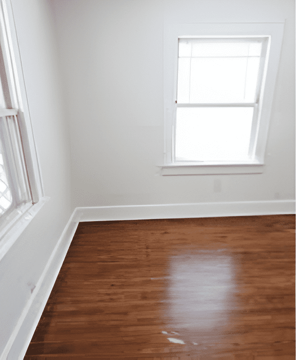 Empty room with freshly refinished shiny wooden floors.
